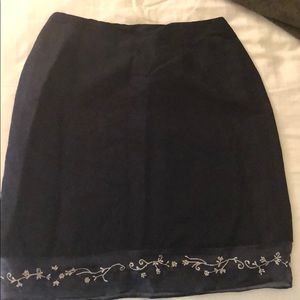 Linen black skirt with embroidered border.